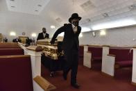 The casket of George Floyd arrives inside the church for a memorial service Saturday, June 6, 2020, in Raeford, N.C. Floyd died after being restrained by Minneapolis police officers on May 25. (Ed Clemente/The Fayetteville Observer via AP, Pool)