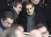 FILE - Former French President Nicolas Sarkozy, right, listens to UEFA President Michel Platini, before the Champions League round of 16 first leg soccer match between Paris Saint Germain and Chelsea at the Parc des Princes stadium in Paris, France, Tuesday, Feb. 17, 2015. Former FIFA president Sepp Blatter repeated on Tuesday, Nov. 8, 2022, his claim that Sarkozy put pressure on Platini, and again gave his version of a telephone call Platini made to him after the Paris meeting that the World Cup voting plan had changed. (AP Photo/Michel Euler, File)