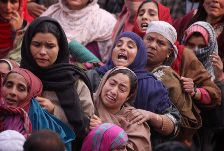 Women mourn as they watch the body of Shahid Ahmad, a suspected militant, who according to police was killed in a gun battle with Indian security forces, before his funeral in Kawani village in south Kashmir's Pulwama district November 23, 2018. REUTERS/Danish Ismail