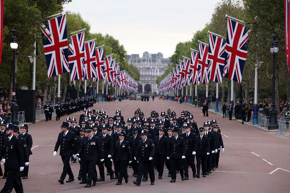 Metropolitan police officers are seen walking in formation down The Mall ahead of the State Funeral of Queen Elizabeth II on September 19, 2022, in London.