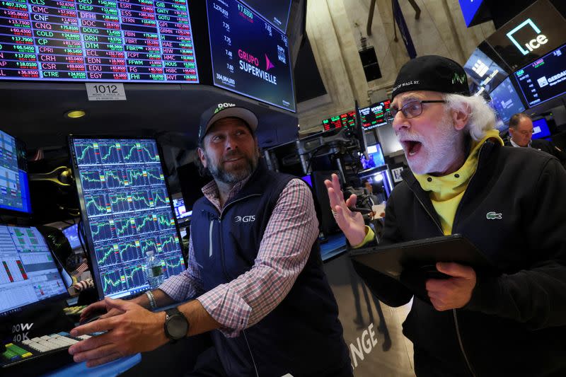 Traders work on the floor at the New York Stock Exchange (NYSE) in New York City