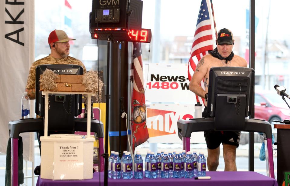 Friend and fellow runner Stephen Strawn, left, kept Bob Mohr company during Mohr's 24-hour treadmill run-a-thon on Friday to raise money for Wishes Can Happen.