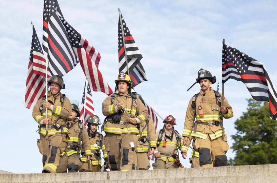 First responders begin to climb the steps of the McKinley National Memorial on Monday during an event commemorating those lost in the Sept. 11, 2001, attacks.