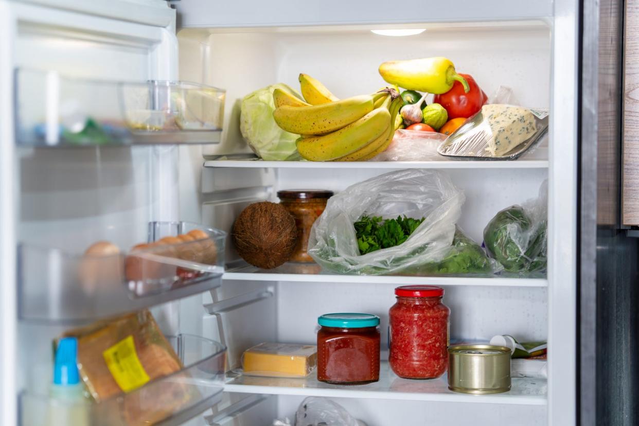 open refrigerator filled with fresh fruits and vegetables