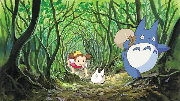 a girl follows two wood trolls in a scene from my neighbor totoro, a good housekeeping pick for best movies for kids and toddlers