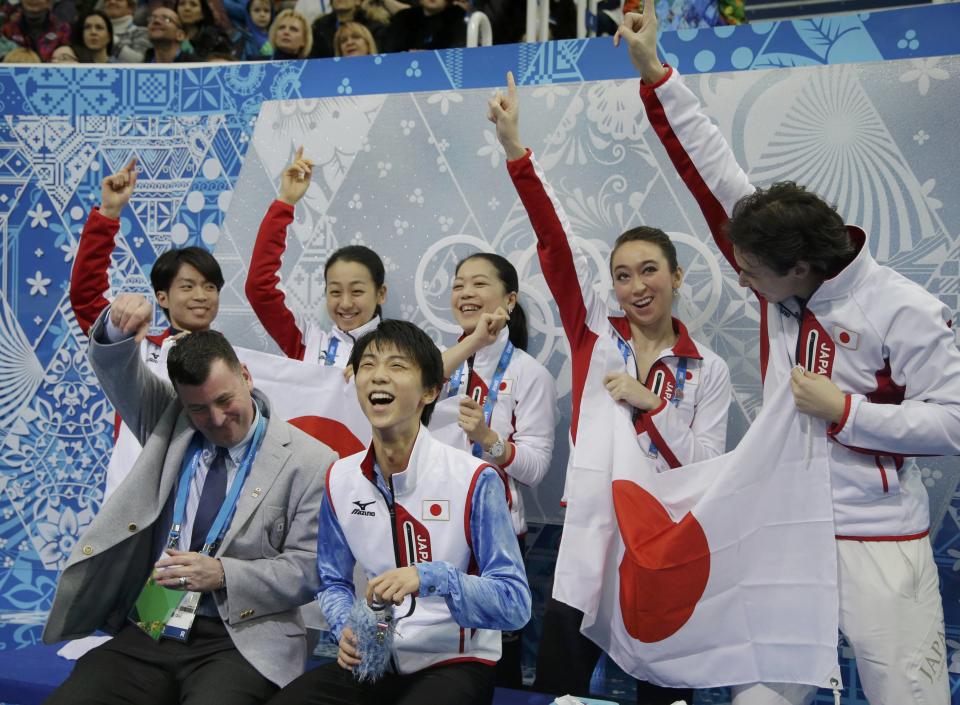 Yuzuru Hanyu of Japan celebrates with his team in the "kiss and cry" area during the Team Men Short Program at the Sochi 2014 Winter Olympics, February 6, 2014. REUTERS/Darron Cummings/Pool