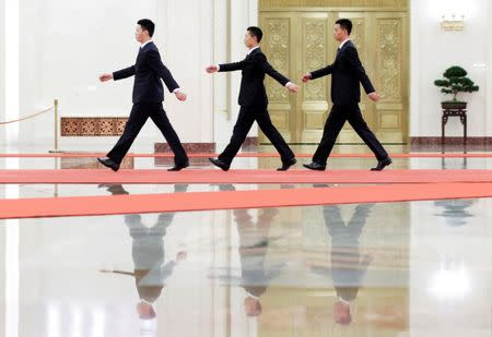 Security personnel walk inside the Great Hall of the People before the meeting between Malaysian Prime Minister Najib Razak and Chinese President Xi Jinping ahead of the Belt and Road Forum in Beijing, China May 13, 2017. REUTERS/Jason Lee