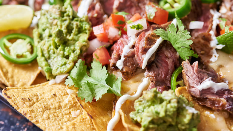 steak and toppings on chips