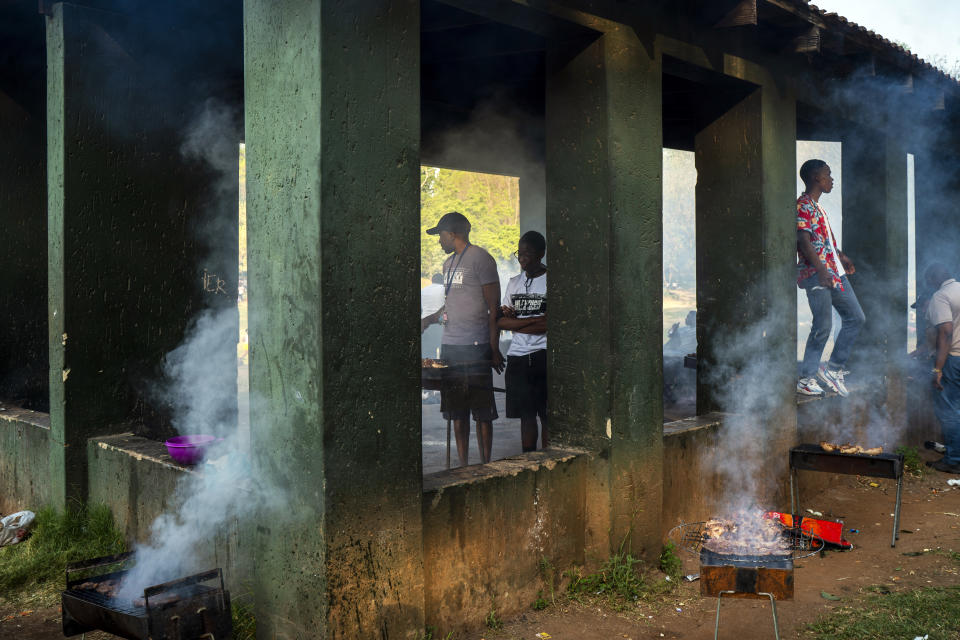 People celebrate South Africa's Heritage Day by cooking a barbecue at Zoo Lake park in Johannesburg Thursday Sept. 24, 2020. As the number of worldwide Covid-19 death is nearing the million mark, coronavirus related case numbers and deaths in South Africa hit the lowest in months. (AP Photo/Jerome Delay)