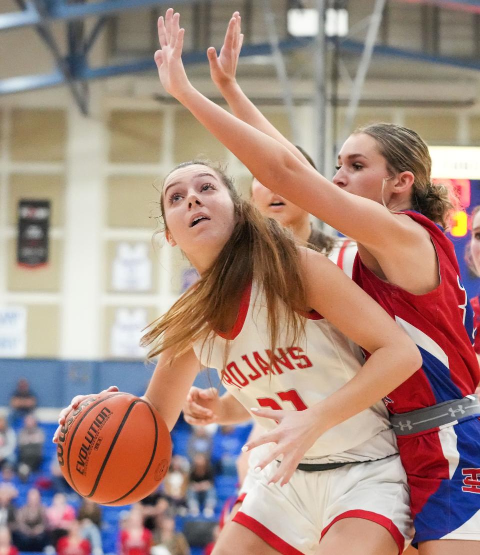 Center Grove Trojans Lilly Bischoff (32) attempts a lay-up against Indian Creek guard Olivia Pendleton (15) on Thursday, Nov. 16, 2023, during the semifinals of the Johnson County Tournament at Franklin Community High School in Franklin. The Center Grove Trojans defeated Indian Creek, 61-52.