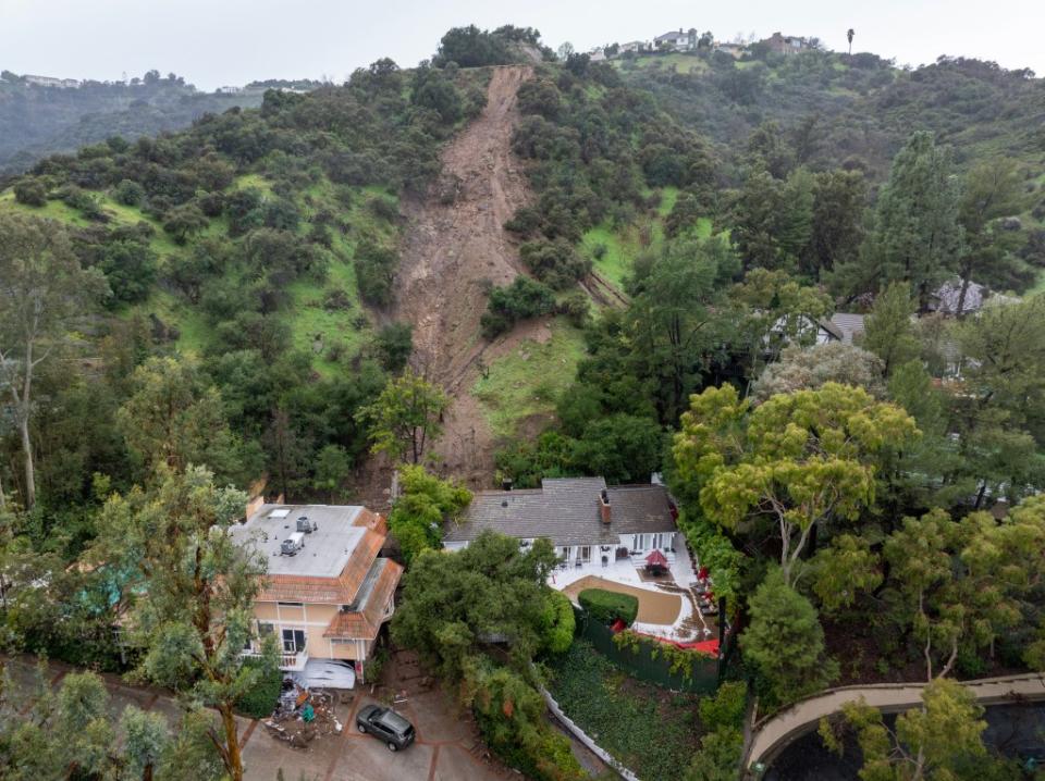 A mudslide leads to a home where it smashed through its garage. AFP via Getty Images