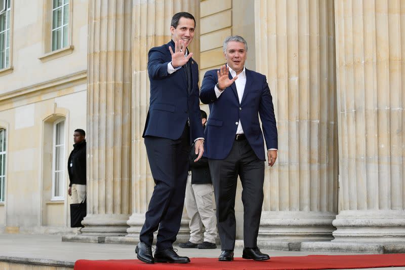 Venezuelan opposition leader Juan Guaido, who many nations have recognised as the country's rightful interim ruler, and Colombia's President Ivan Duque wave before a meeting at the presidential palace in Bogota