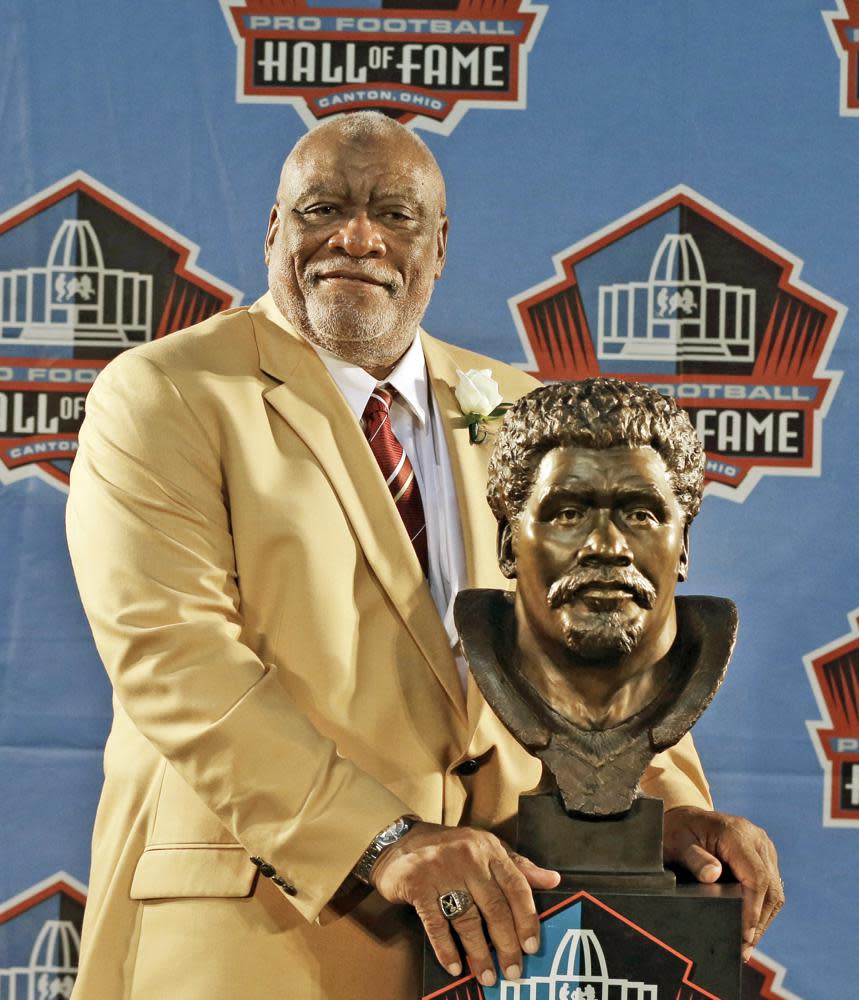 Hall of Fame inductee Claude Humphrey poses with his bust during the 2014 Pro Football Hall of Fame Enshrinement Ceremony at the Pro Football Hall of Fame on Aug. 2, 2014, in Canton, Ohio. (AP Photo/Tony Dejak, File)