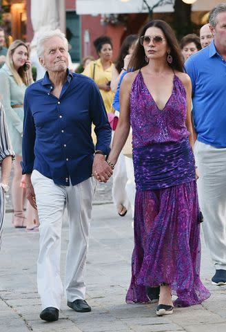 <p>Cobra Team / BACKGRID</p> Catherine Zeta-Jones with her husband Michael Douglas and friends at the "Taverna del Marinaio" in Portofino.