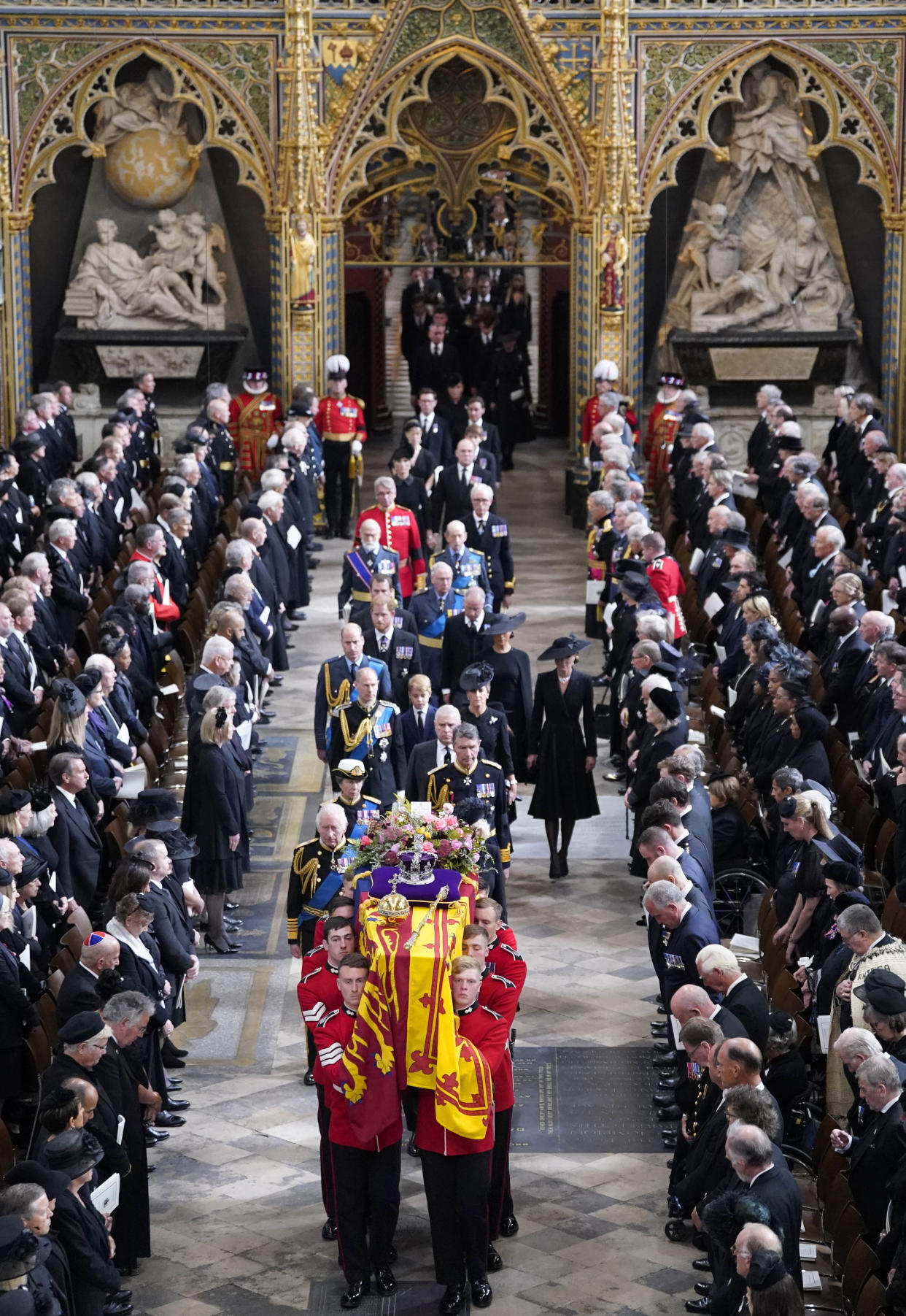 LONDON, ENGLAND - SEPTEMBER 19: King Charles III, the Queen Consort, the Princess Royal, Vice Admiral Sir Tim Laurence, the Duke of York, the Earl of Wessex, the Countess of Wessex, the Prince of Wales, the Princess of Wales, Prince George, Princess Charlotte, the Duke of Sussex, the Duchess of Sussex, Peter Phillips and the Earl of Snowdon follow behind the coffin of Queen Elizabeth II, draped in the Royal Standard with the Imperial State Crown and the Sovereign's orb and sceptre, as it is carried out of Westminster Abbey after her State Funeralon September 19, 2022 in London, England. Elizabeth Alexandra Mary Windsor was born in Bruton Street, Mayfair, London on 21 April 1926. She married Prince Philip in 1947 and ascended the throne of the United Kingdom and Commonwealth on 6 February 1952 after the death of her Father, King George VI. Queen Elizabeth II died at Balmoral Castle in Scotland on September 8, 2022, and is succeeded by her eldest son, King Charles III.  (Photo by Danny Lawson - WPA Pool/Getty Images)