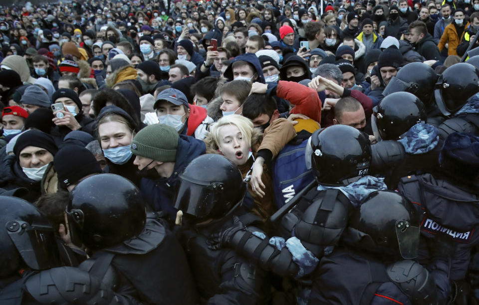 People clash with police during a protest against the jailing of opposition leader Alexei Navalny in St.Petersburg, Russia, Saturday, Jan. 23, 2021. Russian police on Saturday arrested hundreds of protesters who took to the streets in temperatures as low as minus-50 C (minus-58 F) to demand the release of Alexei Navalny, the country's top opposition figure. A Navalny, President Vladimir Putin's most prominent foe, was arrested on Jan. 17 when he returned to Moscow from Germany, where he had spent five months recovering from a severe nerve-agent poisoning that he blames on the Kremlin. (AP Photo/Dmitri Lovetsky)