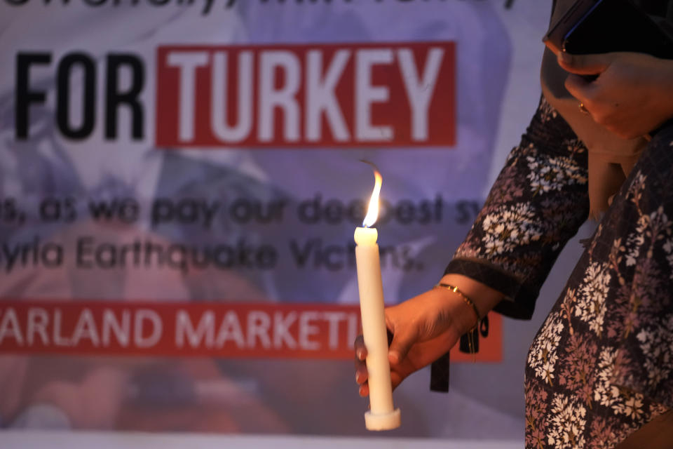 <p>A woman hold a candle during a candle light vigil for the victims of earthquake in Syria and Turkey, in Islamabad, Pakistan, Monday, Feb. 6, 2023. A powerful 7.8 magnitude earthquake has rocked wide swaths of Turkey and Syria. It toppled hundreds of buildings and killed more than 1,900 people. Hundreds are still believed to be trapped under rubble, and the toll is expected to rise as rescue workers search mounds of wreckage in cities and towns across the area. (AP Photo/Anjum Naveed)</p> 