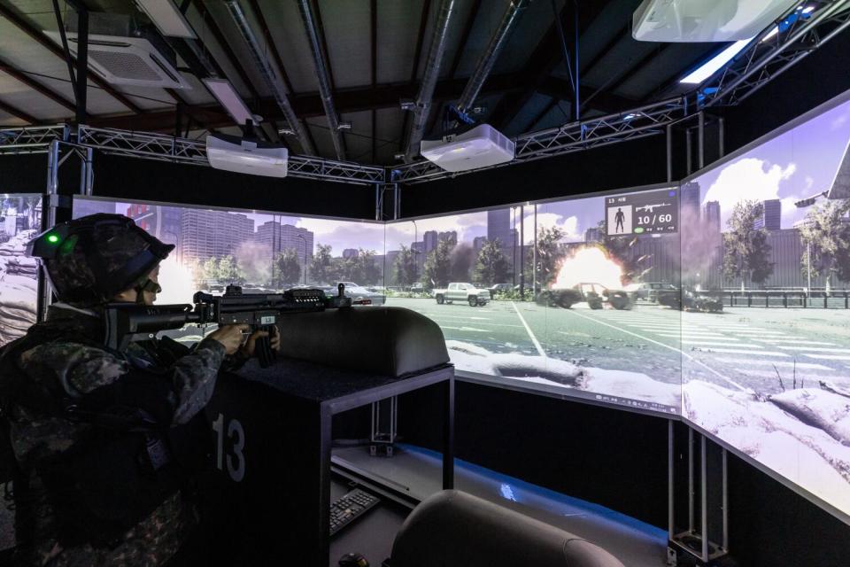 A member of the Senior Army participates in a VR session of urban warfare during military training