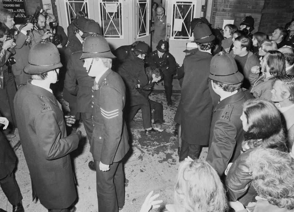 Protestors are restrained by police as the pro-paedophile activist group, the Paedophile Information Exchange (PIE) holds its first open meeting at Conway Hall in Red Lion Square, London, 19th September 1977. Members of PIE were attacked and pelted with eggs, stink bombs and rotten fruit as they arrived at the meeting. (Photo by Malcolm Clarke/Keystone/Hulton Archive/Getty Images)