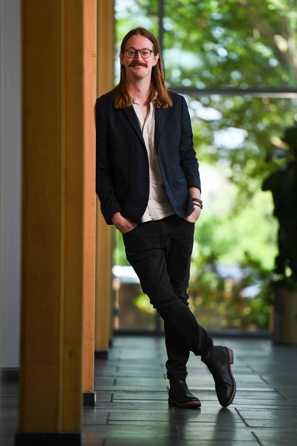 Tyler Prescott, cofounder and CEO of Upstate LGBTQ+ Chamber of Commerce, poses for a portrait at Hughes Main Library in Greenville, S.C., on Monday, June 26, 2023. 