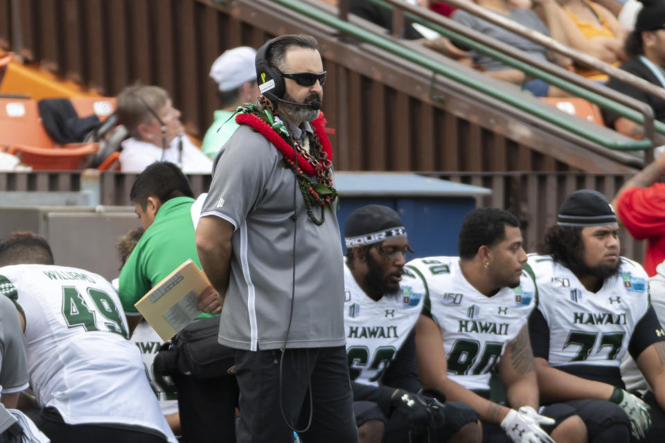 Hawaii coach Nick Rolovich watches during the first half of the team's Hawaii Bowl NCAA college football game against BYU, Tuesday, Dec. 24, 2019, in Honolulu. (AP Photo/Eugene Tanner)