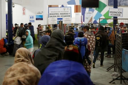 Venezuelans line up to cross into Ecuador from Colombia, as new visa restrictions from the Ecuadorian government took effect, at Rumichaca border bridge in Tulcan