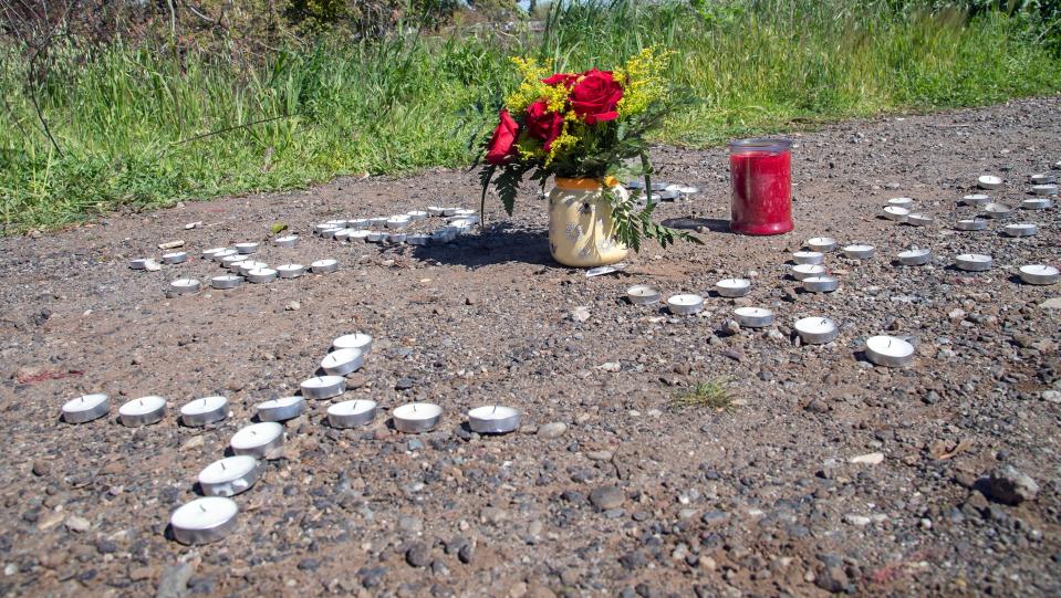 A roadside memorial is set up on River Drive along the Calaveras River in Stockton near where a 15-year-old Stagg High School student went missing when he jumped into the river after a fight on campus.
