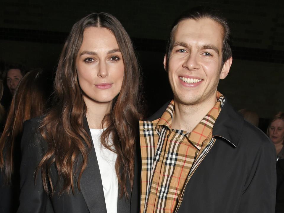 Keira Knightley (L) and James Righton wearing Burberry at the Burberry February 2018 show during London Fashion Week at Dimco Buildings on February 17, 2018 in London, England
