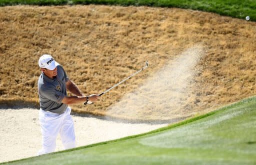 Lee Westwood of England hits a shot from a bunker on the second hole during the quarterfinal round of the World Golf Championships-Accenture Match Play Championship at the Ritz-Carlton Golf Club in Marana, Arizona. Rory McIlroy and Westwood, each seeking a title to become World No. 1, advanced to a semi-final showdown