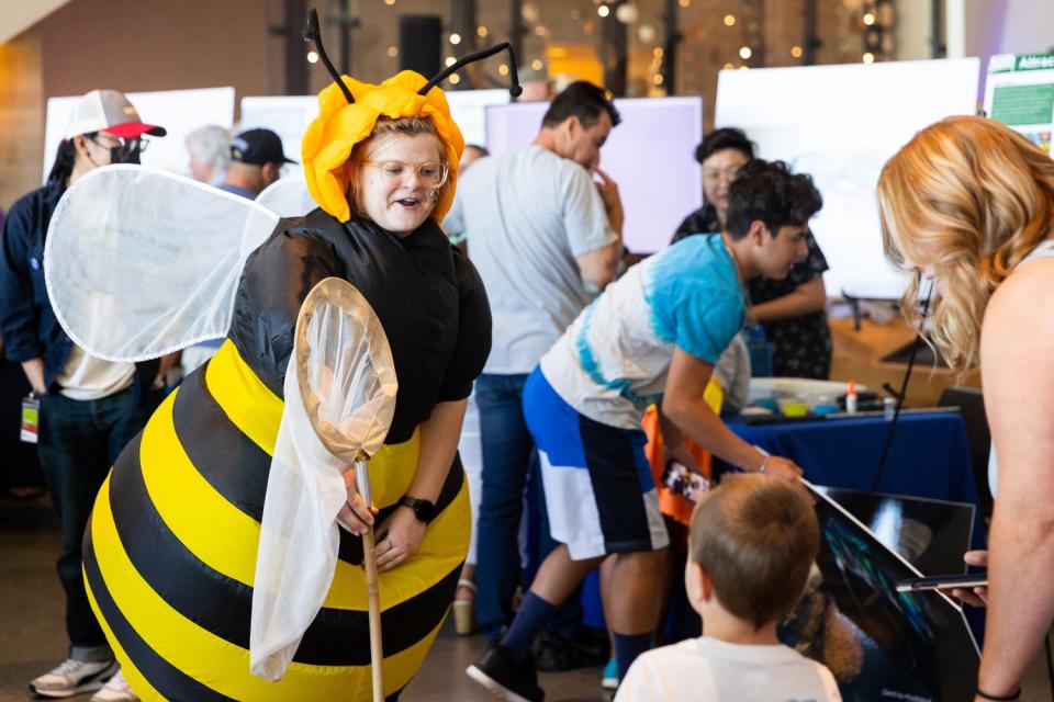 Bailey Basinger from the Utah State University bee lab wears a bee costume at BUGfest at the Natural History Museum of Utah in Salt Lake City on Saturday.