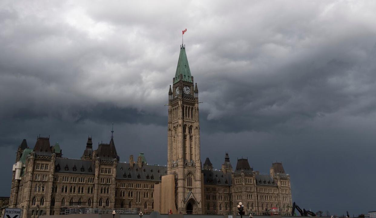 Ominous storm clouds pass by Parliament Hill in 2020. Environment Canada has issued several thunderstorm watches and warnings for the region, although it has lifted a tornado warning for the Deep River, Ont., area. (Adrian Wyld/The Canadian Press - image credit)