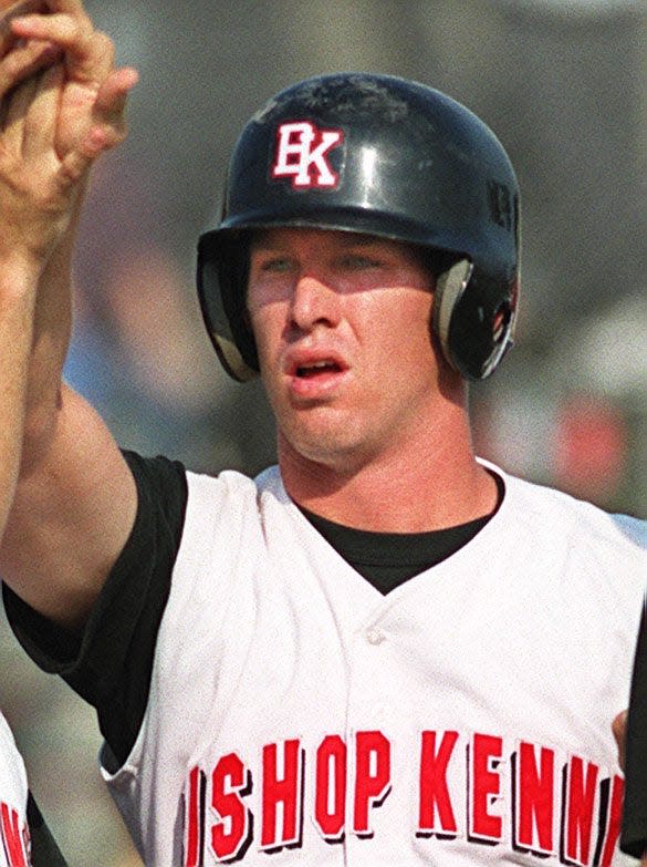 Bishop Kenny catcher Tony Richie (23) is congratulated by teammates after scoring the go-ahead run in a May 2000 playoff game against Palatka.