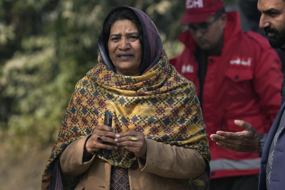A woman grieves close to the site of bomb explosion, in Islamabad, Pakistan, Friday, Dec. 23, 2022. A powerful car bomb detonated near a residential area in the capital Islamabad on Friday, killing some people, police said, raising fears that militants have a presence in one of the country's safest cities. (AP Photo/Anjum Naveed)