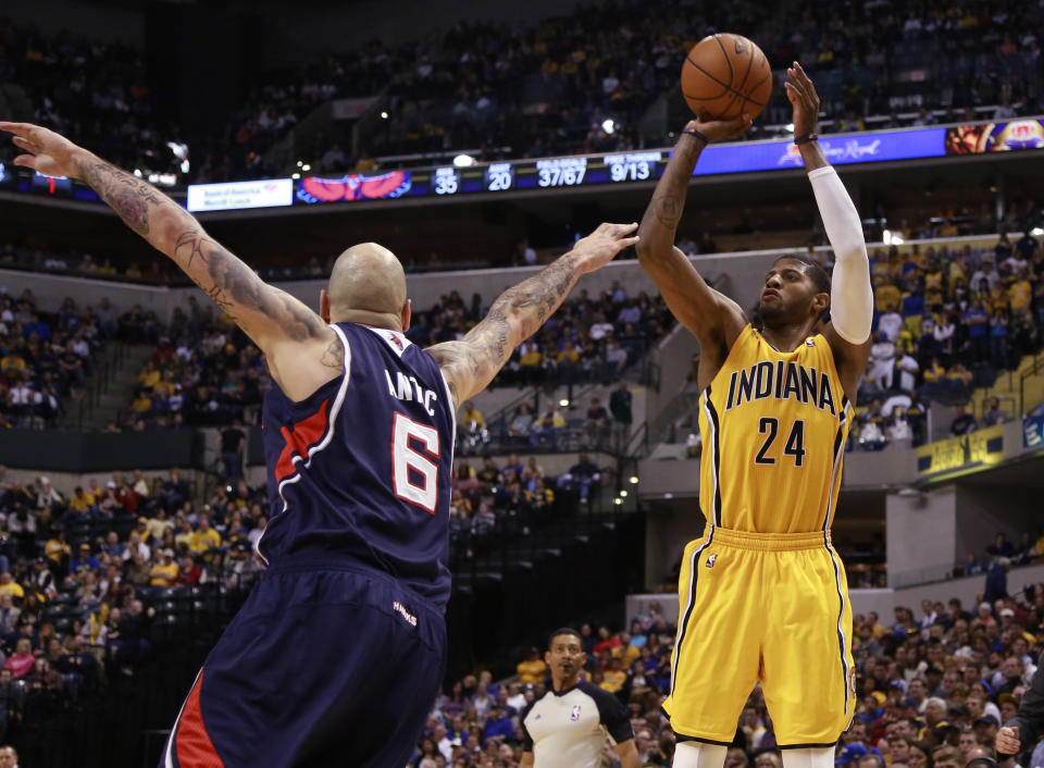 Indiana Pacers forward Paul George (24) shoots the basketball defended by Atlanta Hawks center Pero Antic in the second half of an NBA basketball game in Indianapolis, Sunday, April 6, 2014. Atlanta won 107-88. (AP Photo/R Brent Smith)