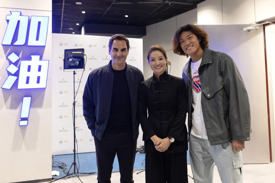 Roger Federer, Li Na, and Zhang Zhizhen pose for photos during the Shanghai Rolex Masters. Li wore a jacket by Samuel Gui Yang for the occasion.