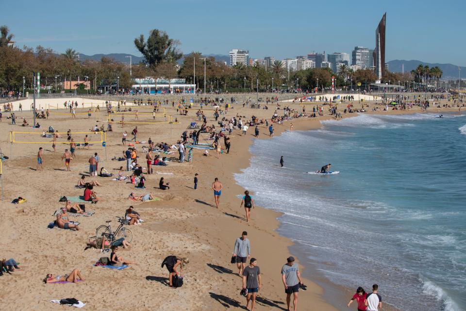 People sunbathe at the Bogatell beach in Barcelona