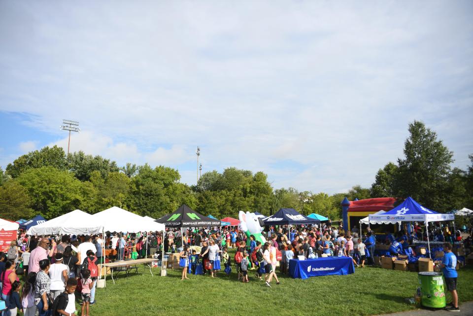 Families browse booths at Knoxville Area Urban League’s Shoes for School event in Caswell Park, Saturday, Aug. 6, 2022.