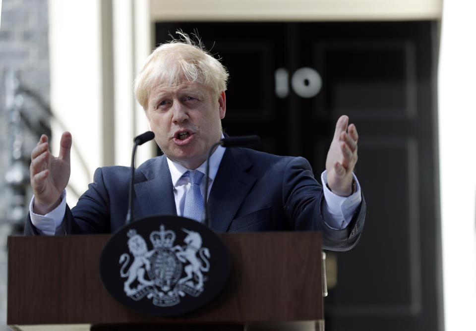 Britain's new Prime Minister Boris Johnson gestures as he speaks outside 10 Downing Street, London, Wednesday, July 24, 2019. Boris Johnson has replaced Theresa May as Prime Minister, following her resignation last month after Parliament repeatedly rejected the Brexit withdrawal agreement she struck with the European Union. (AP Photo/Frank Augstein)