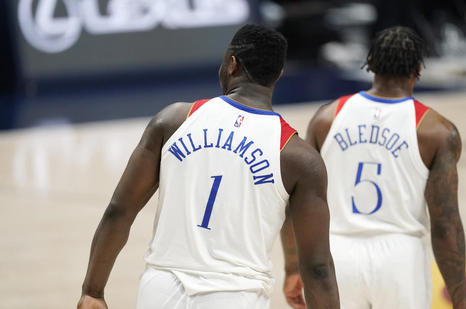 After his last-second shot was blocked by Denver Nuggets center Nikola Jokic, New Orleans Pelicans forward Zion Williamson (1) follows guard Eric Bledsoe (5) toward the team huddle in the second half of an NBA basketball game against the Denver Nuggets Wednesday, April 28, 2021, in Denver. The Nuggets held on to win 114-112. (AP Photo/David Zalubowski)