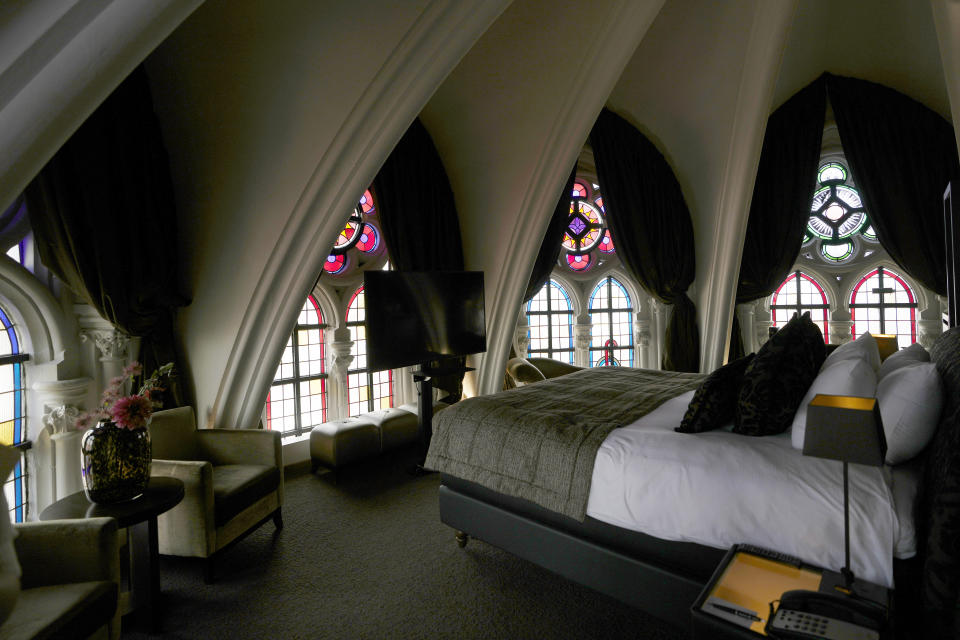 Sunlight filters in through stained glass windows in a guest room at the Martin's Patershof hotel in the center of Mechelen, Belgium, Monday, June 19, 2023. Across Europe, the continent that nurtured Christianity for most of two millennia, many churches, convents, beguinages and chapels stand empty as faith and church attendance have dwindled over the past half century. Many are now been repurposed to preserve their historical and architectural relevance, while others have opened up to non-religious activities to expand their use. (AP Photo/Virginia Mayo)