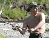 Russia's President Vladimir Putin fishes in the Yenisei River in Siberia as he makes a tour together with Prince Albert II of Monaco, August 13, 2007. REUTERS/RIA Novosti/KREMLIN