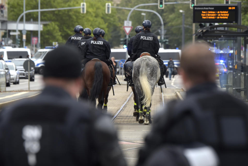 Mounted police patrol in Chemnitz, eastern Germany, Saturday, Sept. 1, 2018, after several nationalist groups called for marches protesting the killing of a German man last week, allegedly by migrants from Syria and Iraq. (AP Photo/Jens Meyer)