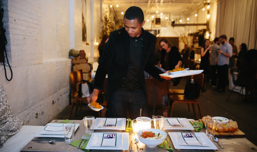 Boubacar Diallo serves food he prepared at an event for Emma's Torch. (Photo: Photo courtesy of Our Name Is Farm)