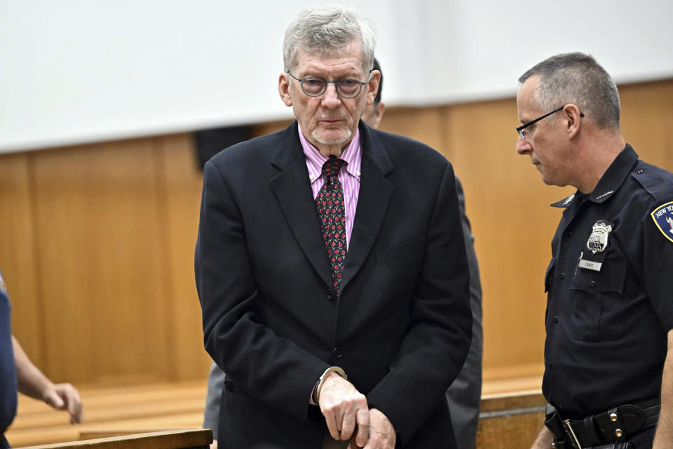 Lawrence Gray, center, a retired political science professor, is handcuffed was he appears at his arraignment in Manhattan criminal court, Tuesday, Aug. 15, 2023, in New York. Gray, 79, pleaded not guilty Tuesday to charges that he robbed four people of rare and valuable pieces that included diamond earrings, a pink sapphire brooch, and a 19th-century gold pocket watch. He earned more than $45,000 in profit selling the stolen goods at a Manhattan auction house, prosecutors alleged. (Curtis Means/Daily Mail via AP)