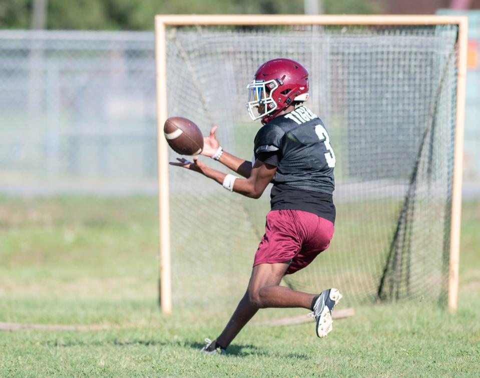 De'andre Barr (3) receives a pass during football practice at Pensacola High School on Wednesday, Aug. 9, 2023.