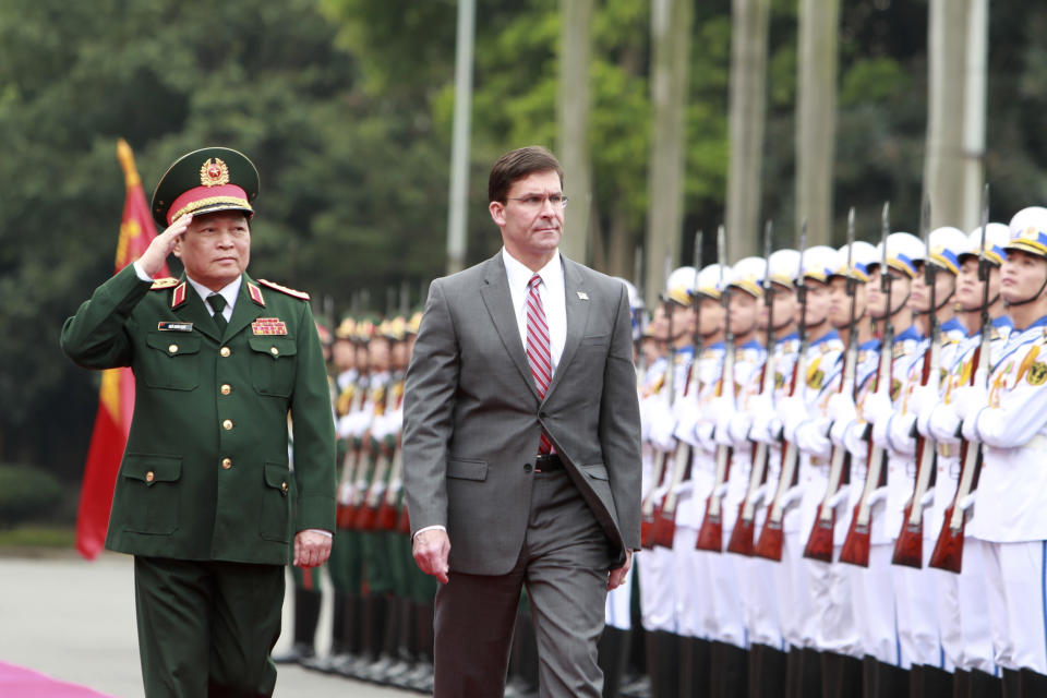 U.S. SDefense Secretary Mark Esper, right, and Vietnamese Defense Minister Ngo Xuan Lich review an honor guard in Hanoi, Vietnam on Wednesday, Nov. 20, 2019. Esper is on a visit to Vietnam to strengthen the military relations with the Southeast Asian nation. (AP Photo/Hau Dinh)