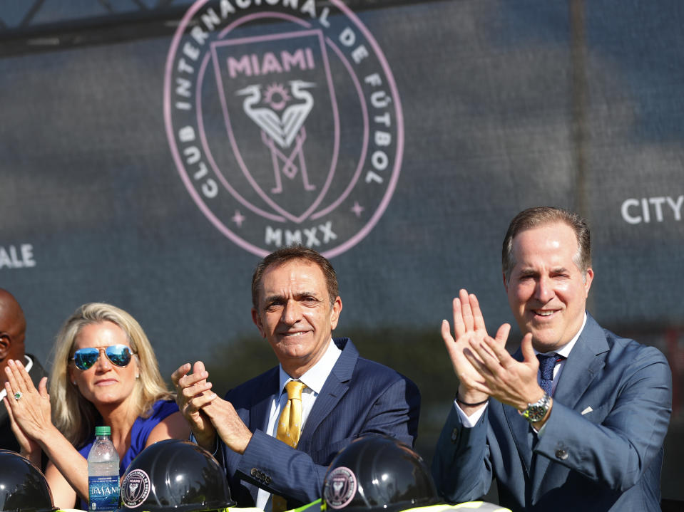 Fort Lauderdale Mayor Dean Trantalis, center, is flanked by city commissioner Heather Moraitis, left, and Inter Miami CF majority owner Jorge Mas as they applaud during ceremonies before the demolition of Lockhart Stadium, Wednesday, May 8, 2019, in Fort Lauderdale. A new stadium will be built at that site and will serve as the temporary home for Inter Miami CF while its permanent stadium is built at Freedom Park in Miami. (AP Photo/Wilfredo Lee)