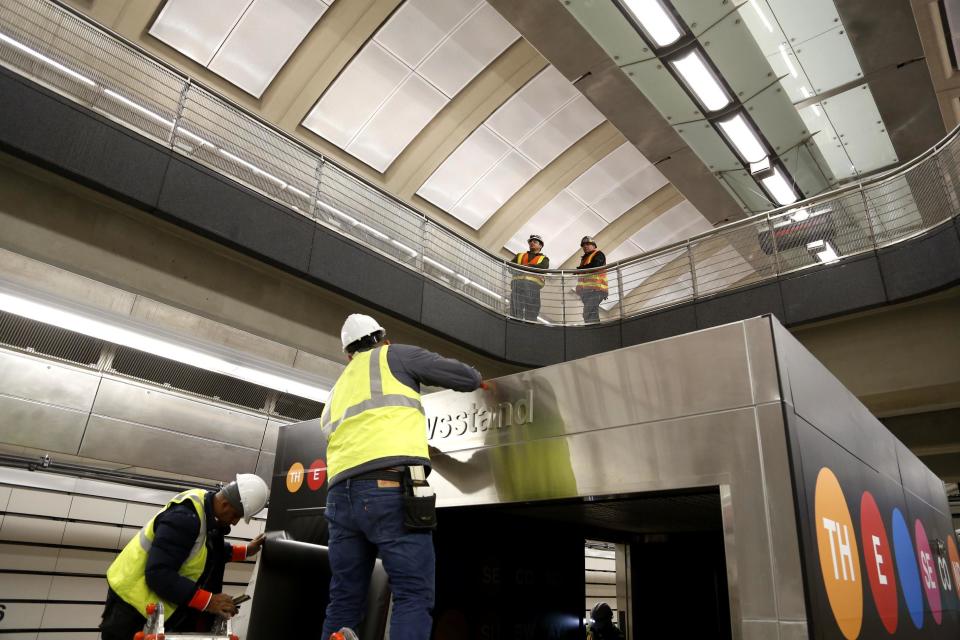 In this Dec. 22, 2016 photo, workers put the finishing touches on the new 86th Street subway station on the new Second Avenue line in New York. The first phase of the 2nd Avenue subway line, which has three stops, begins operation Sunday, on Jan. 1, 2017. (AP Photo/Seth Wenig)