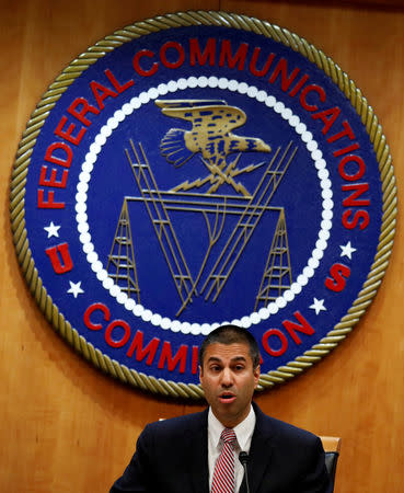 FILE PHOTO: Chairman Ajit Pai speaks ahead of the vote on the repeal of so called net neutrality rules at the Federal Communications Commission in Washington, U.S., December 14, 2017. REUTERS/Aaron P. Bernstein/File Photo