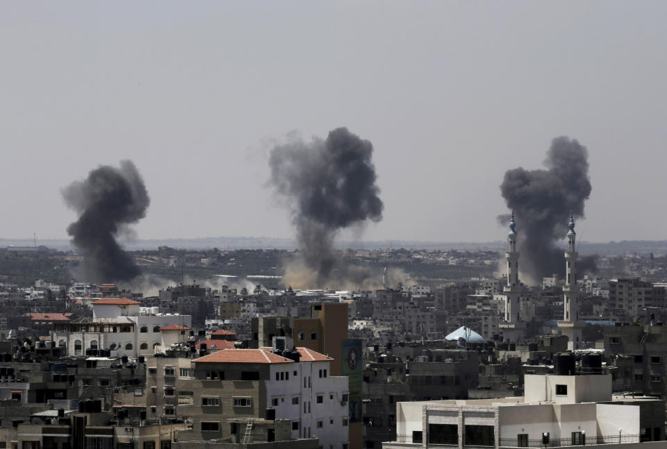 FILE - In this July 16, 2014 file photo, smoke rises after Israeli missile strikes hit the northern Gaza Strip. Israel said Thursday, April 8, 2021, it will formally reject the International Criminal Court’s decision to launch a probe into potential war crimes against the Palestinians. The court is expected to look at possible war crimes committed by Israelis forces and Palestinian militants during and after the 2014 Gaza war, as well as Israel’s settlements in the West Bank and east Jerusalem. (AP Photo/Adel Hana, File)